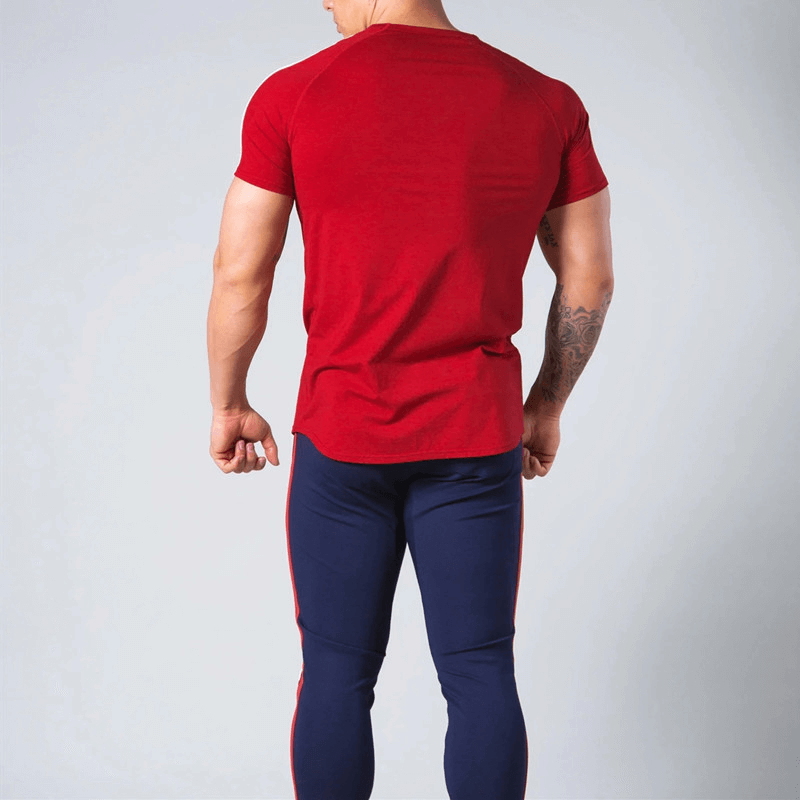 Back view of man wearing red Running Cotton T-Shirt with Striped-on Sleeves and blue pants, showcasing short sleeves and O-neck design.